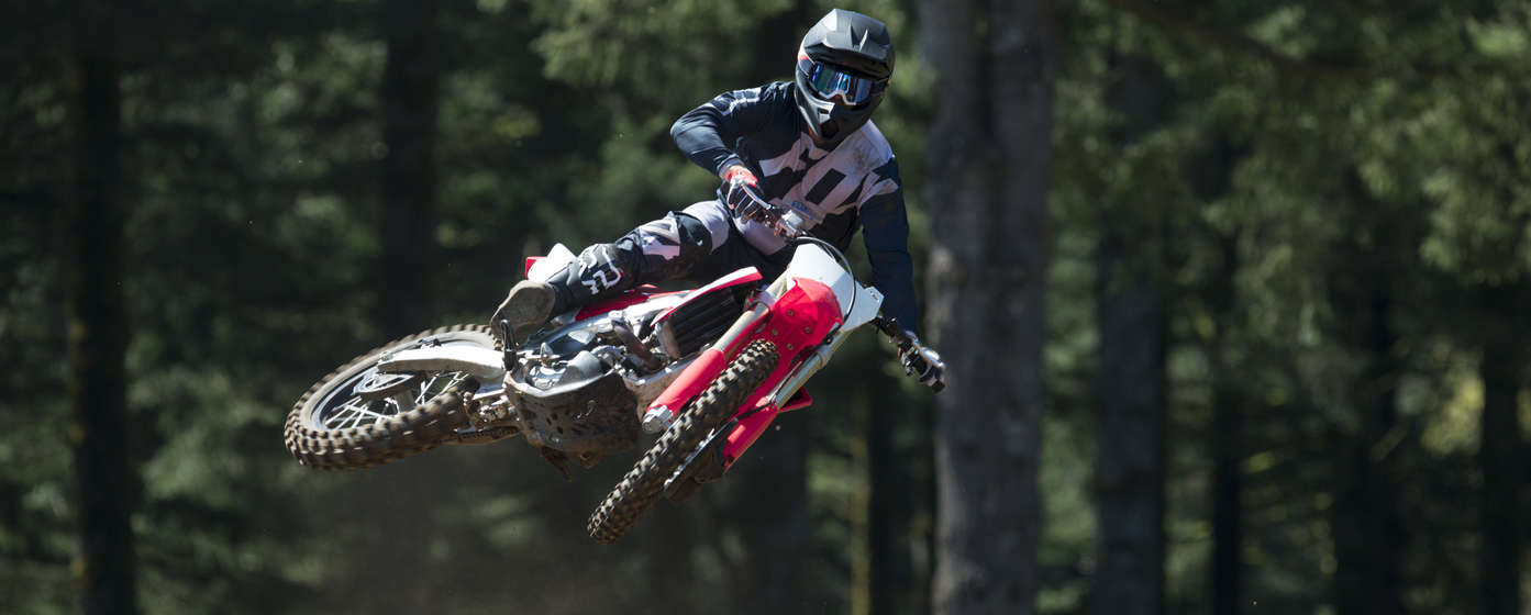 Frontalaufnahme einer CRF450R mit Fahrer im Sprung.