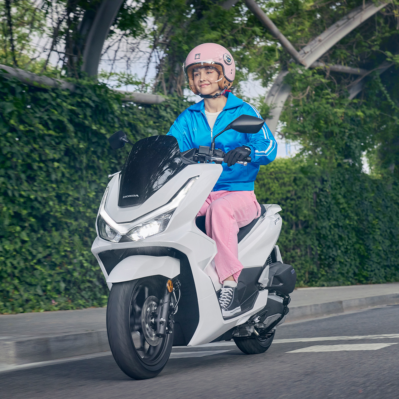 Model fährt den PCX125 in der Stadt.