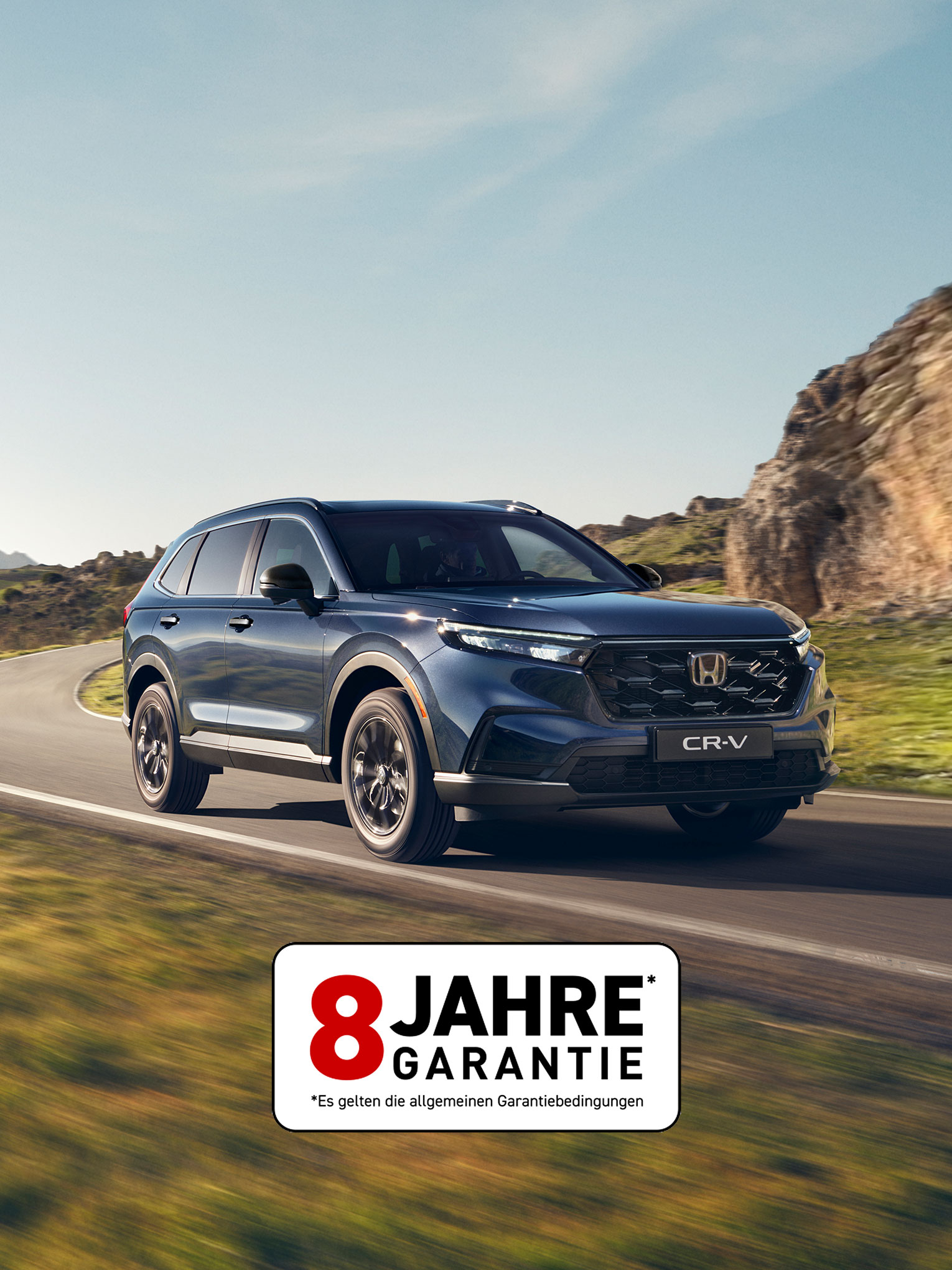 CR-V Plug in Hybrid Suv car driving on the road in a mountain location.
